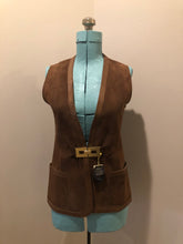 Load image into Gallery viewer, Vintage Mills Brothers deadstock 1960’s brown suede vest with large gold geometric front clasp, leather lining and trim and two patch pockets in the front. Suede and leather are buttery soft. Made in England - Kingspier Vintage
