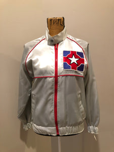 Kingspier Vintage - Milk and Honey - John Lennon and Yoko Ono Roadie Tour Jacket from the mid 1980’s. A very rare collectors piece from John Lennon’s last studio album. Jacket is light grey nylon with satin effect with two slash pockets, elastic waist and cuffs, chunky red zip up front with popper at the collar. The jacket features a star logo on the front and Milk and honey logo on the back with a rainbow. Made in the USA. Size XS. 
