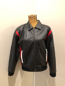 Kingspier Vintage - Two Plus Two black leather jacket with red and white details, large American flag on the back with USA written across the bottom. Slash pockets zipper closure, one inside pocket, nylon lining, knit cuffs and trim.