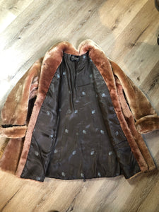 Vintage mid century blonde fur coat with unique blush undertones. Hook and eye closures with front pockets and satin lining with floral motif. Fur type unknown but it feels like shorn beaver fur - Kingspier Vintage