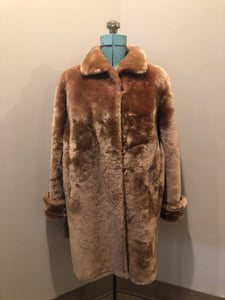 Vintage mid century blonde fur coat with unique blush undertones. Hook and eye closures with front pockets and satin lining with floral motif. Fur type unknown but it feels like shorn beaver fur - Kingspier Vintage