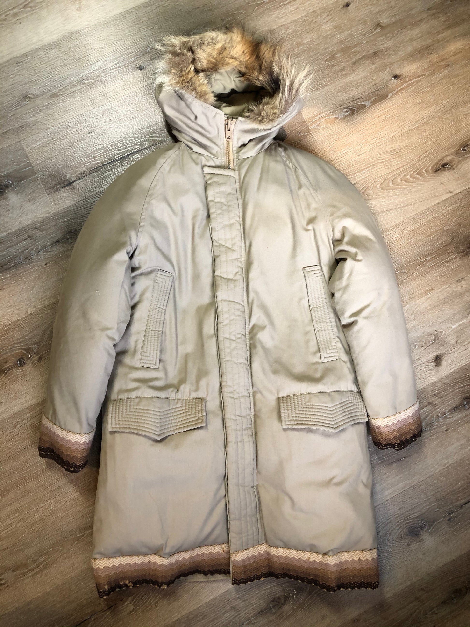 Kingspier Vintage - Vintage Rice Sportswear beige down-filled parka, with a fox fur trimmed hood. This exceptionally warm parka has embroidered ribbon detail in the cuffs and bottom hem. Parka features zipper and ribbon button closures, flap pockets and handwarmer pockets, Size medium. Made in Canada.