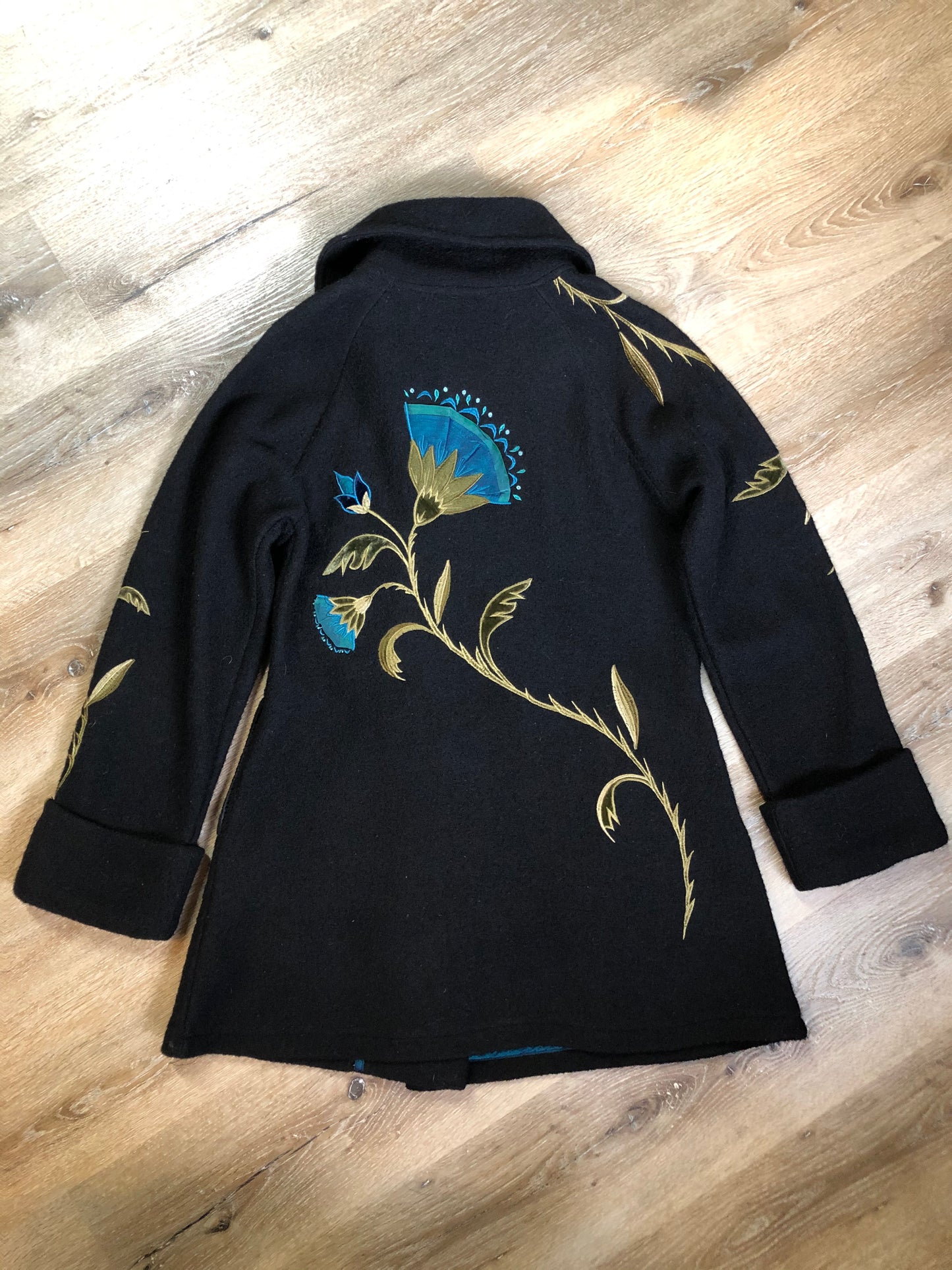 Kingspier Vintage - CoVelo Clothing black wool jacket with flower embellishments. Snap closures, side pockets and embroidered swirl decorative buttons. Size large.
