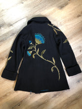 Load image into Gallery viewer, Kingspier Vintage - CoVelo Clothing black wool jacket with flower embellishments. Snap closures, side pockets and embroidered swirl decorative buttons. Size large.

