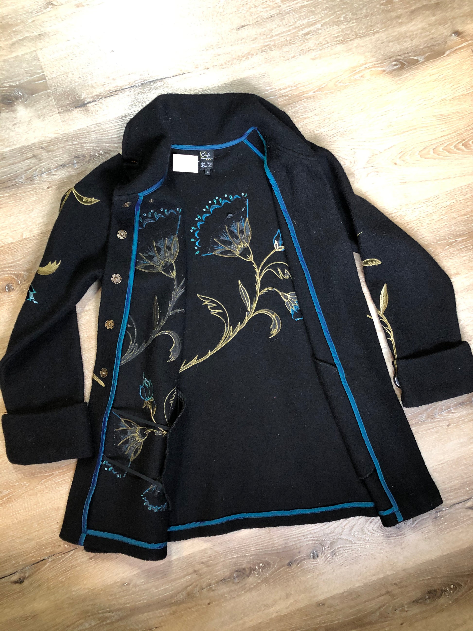 Kingspier Vintage - CoVelo Clothing black wool jacket with flower embellishments. Snap closures, side pockets and embroidered swirl decorative buttons. Size large.
