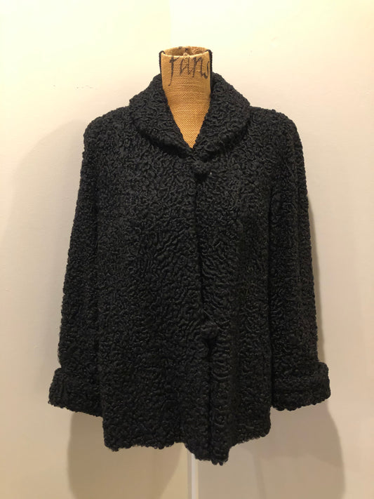 Kingspier Vintage - Vintage Rideau Furs black persian wool coat with wool buttons, pockets and black satin lining with delicate flower motif. Made in Nova Scotia. Size small/ medium.