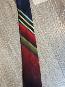 Kingspier Vintage - Playboy tie with navy, red, yellow and green design. Fibres unknown. 

Length: 57.5” 
Width: 2.5” 

This tie is in excellent condition.