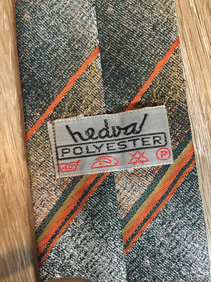 Kingspier Vintage - Hedval 100% polyester tie with silver, mustard, orange and green stripes.

Length: 59”
Width: 2.5” 

This tie is in excellent condition.