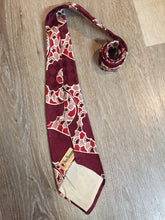 Load image into Gallery viewer, Kingspier Vintage - Van Heussen de Luxe in burgundy, red, cream and brown design on a subtle checkerboard background. Fibres unknown.

Length: 53” 
Width: 4”

This tie is in excellent condition.
