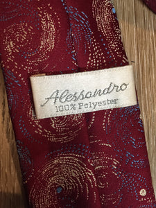 Kingspier Vintage - Alessandro 100% polyester tie with red, blue and cream subtle swirl design.

Length: 56.6”
Width: 2.5” 

This tie is in excellent condition.