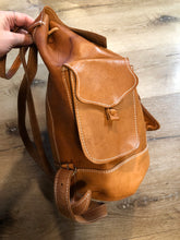 Load image into Gallery viewer, Vintage full grain leather backpack in light brown with top carry handle, flap closure, interior drawstring, three exterior compartments and adjustable shoulder straps Kingspier Vintage
