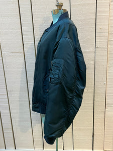 Vintage USAF Cobles Clothing Division Blue Flyer’s Man Intermediate MA. 1 Jacket. Based on original MIL-J-8279E.

100% nylon shell with polyester fill, blaze orange safety lining, zipper closure, two front slash pockets and a pocket on the left arm.

Size Medium