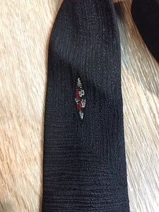 Kingspier Vintage - Gentry tie in black with red, white, yellow diamond motif. Fibres unknown.

Length: 52”
Width: 2.25” 

This tie is in excellent condition.