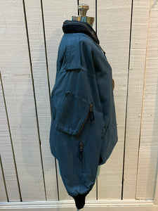 Vintage 1994 RCAF W8473-3ANON/01-PE Blue Bomber Jacket with zipper closure, multiple zip pockets and packaway hood.

Chest 52”