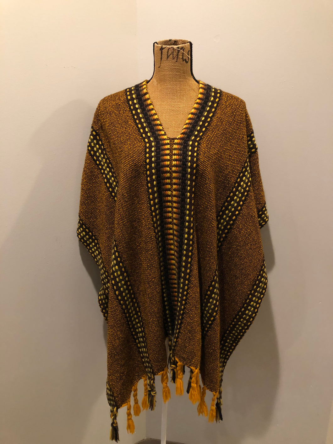 Kingspier Vintage - Vintage wool poncho with yellow, orange and brown designs and tassels on the bottom