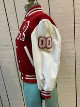 Load image into Gallery viewer, Roots Athletics circa 2000 red and white varsity jacket with wool blend body, leather sleeves, snap closures, two front slash pockets, “R” patch on the chest, Canada flag patch on the arm, “00” patch on the arm and “Canada” written across the back.

Made in Canada
Size Youth Medium
