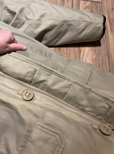 Vintage Sears “The Mens Store” beige down-filled parka (60% duck down/ 40% waterfowl feather) with cotton/nylon blend shell, zipper and button closures, two hand-warmer pockets, two flap pockets, two inside zip pockets, hood with fur trim and storm cuffs.

Made in Canada
Size Small 34-36