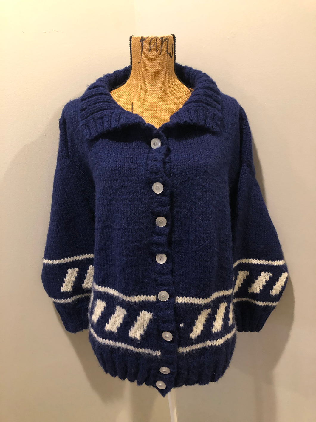Kingspier Vintage - Hand knit royal blue cardigan with white design, collar and button closures. Made in Nova Scotia, Canada. Size large.
