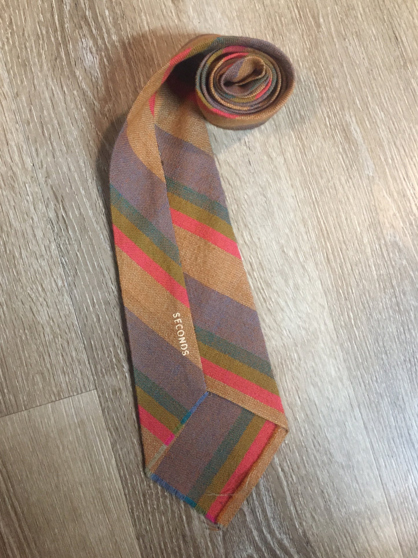 Kingspier Vintage - Seconds brown, orange, green and blue striped tie. Fibres unknown.

Length: 56” 
Width: 4.25” 

This tie is in excellent condition.