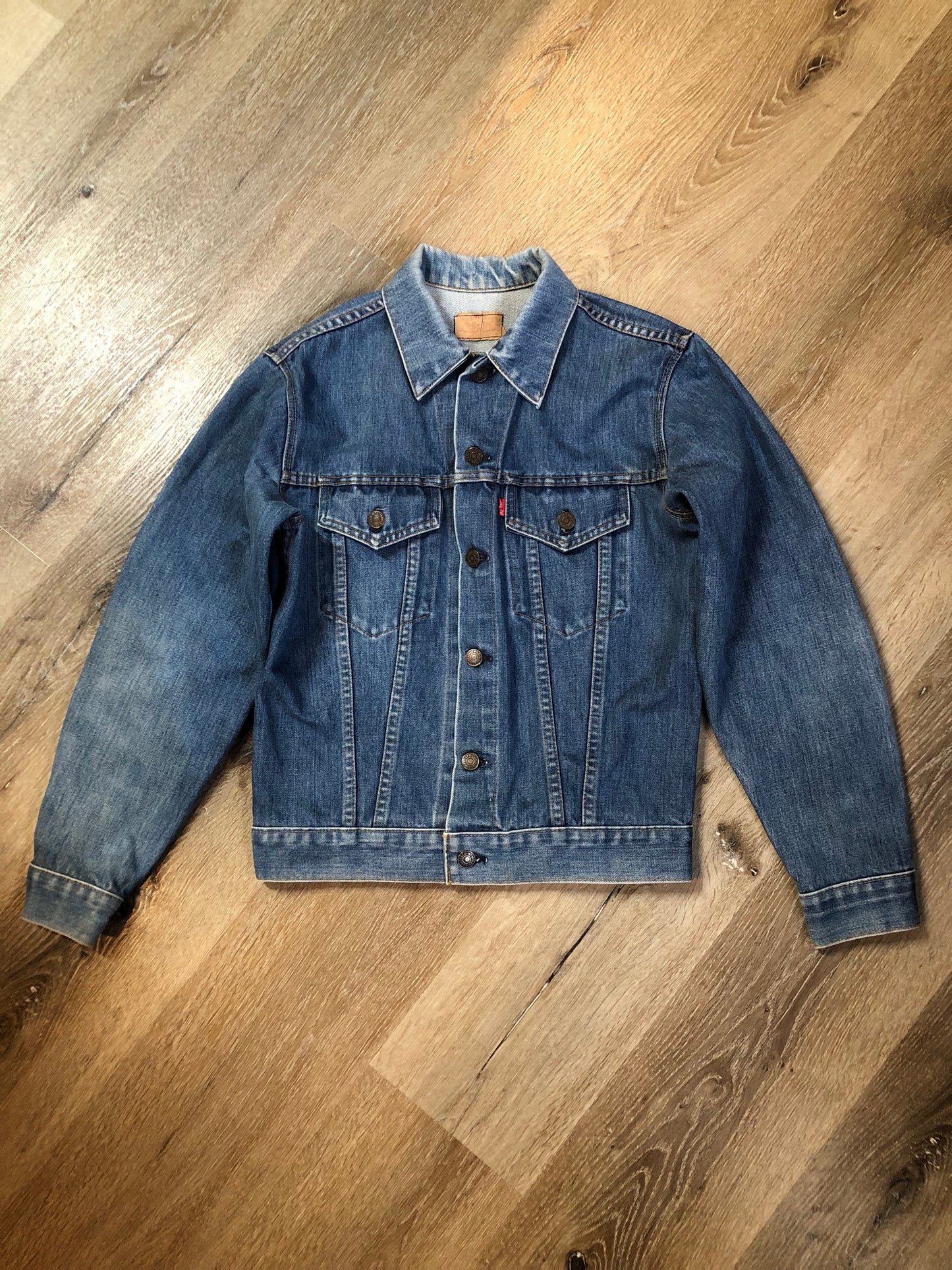 Vintage 1970’s Levi’s medium wash denim trucker jacket with button closures and two flap pockets on the chest.  Red Tab, 100% cotton, made in USA, size 18 - Kingspier Vintage