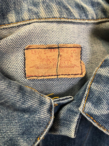 Vintage 1970’s Levi’s medium wash denim trucker jacket with button closures and two flap pockets on the chest.  Red Tab, 100% cotton, made in USA, size 18 - Kingspier Vintage
