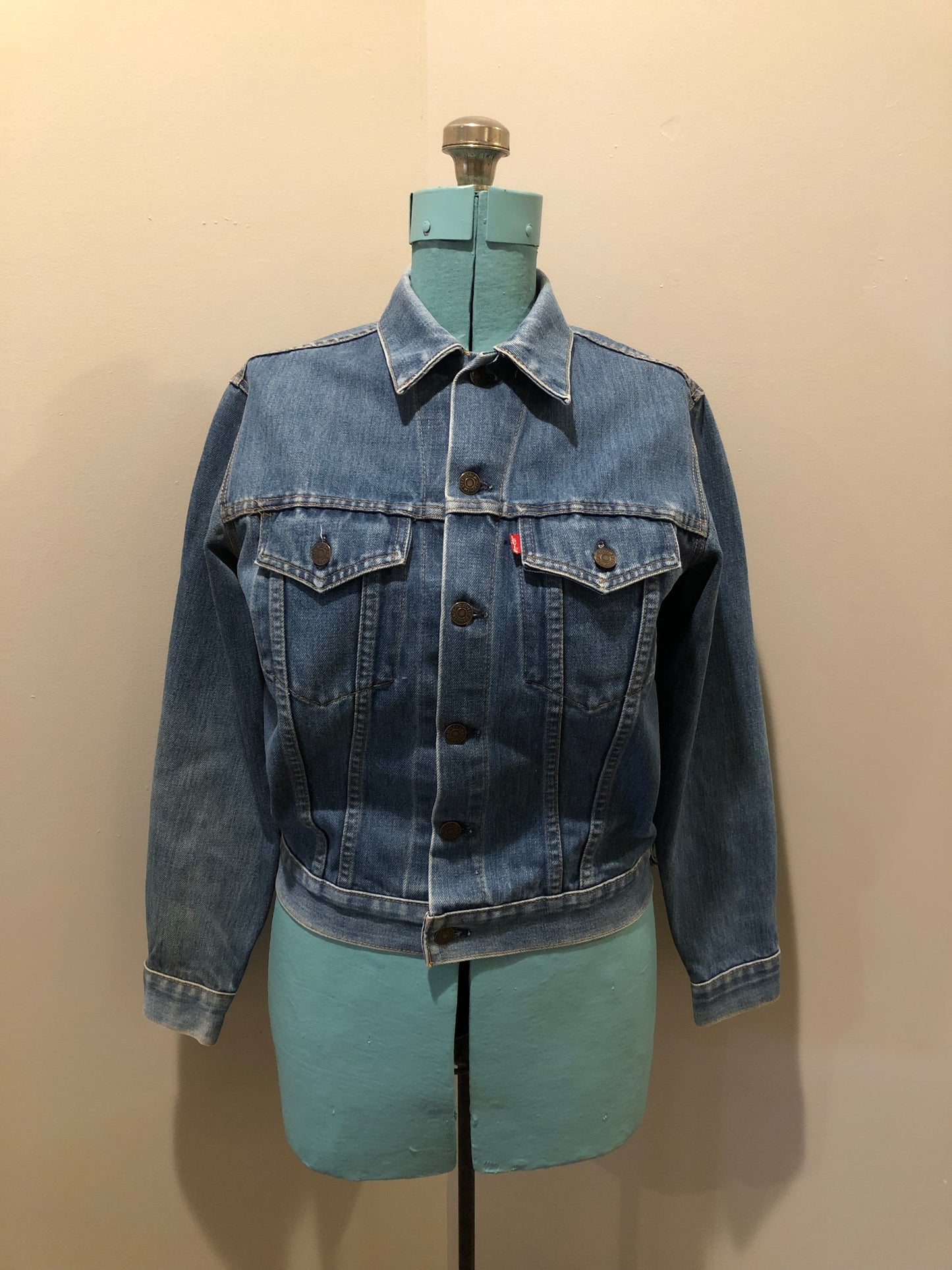 Vintage 1970’s Levi’s medium wash denim trucker jacket with button closures and two flap pockets on the chest.  Red Tab, 100% cotton, made in USA, size 18 - Kingspier Vintage