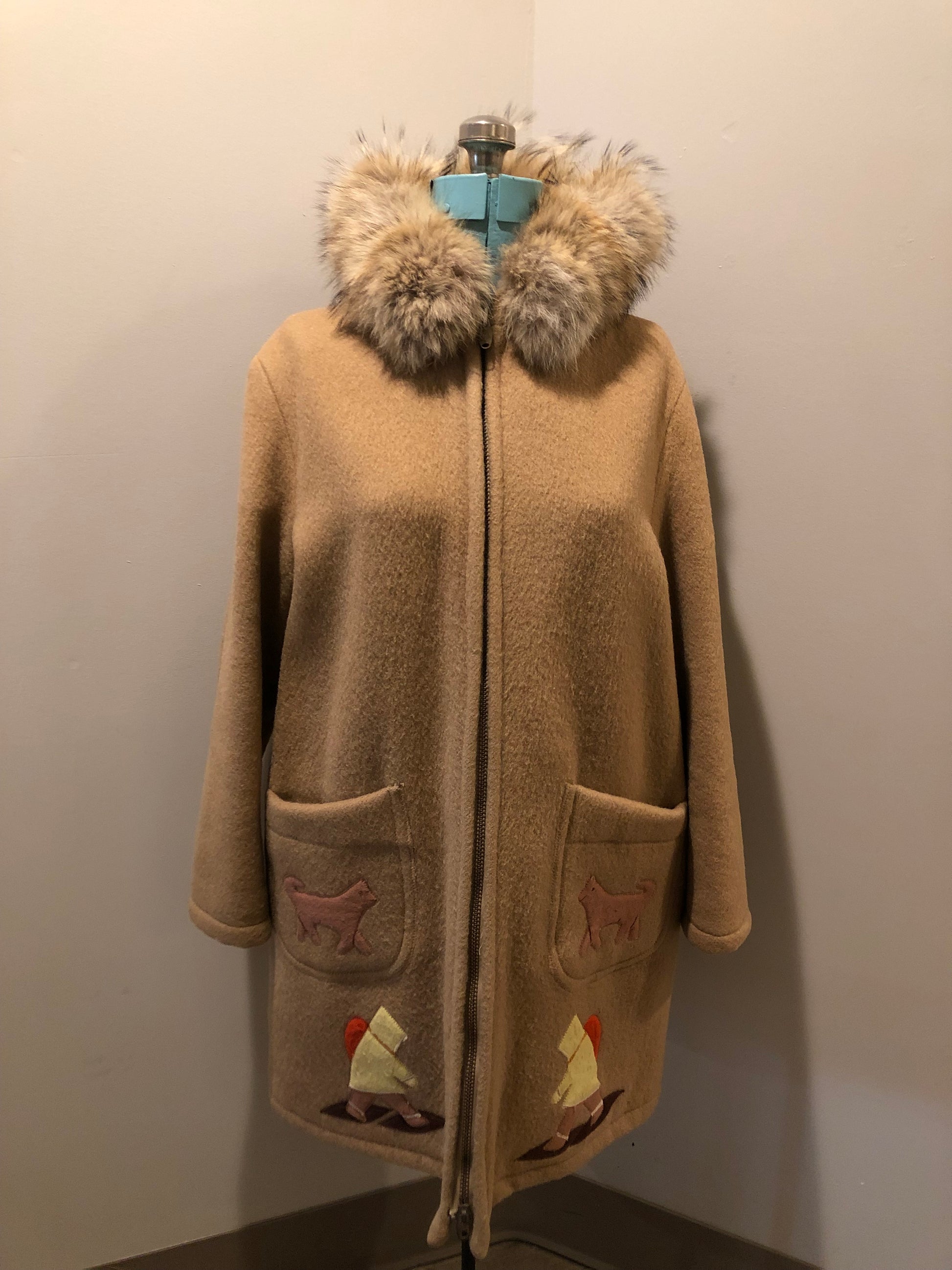 Vintage Inuvik Sewing Company brown 100% pure wool parka.  This parka features a cotton/ polyester blend storm shell with embroidered details, a fur trimmed hood, zipper closure, patch pockets, satin lining and a snowshoeing design in felt applique. Made in northern Canada - Kingspier Vintage