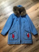 Load image into Gallery viewer, Vintage James Bay 100% pure wool northern parka in sky blue.  This parka features a fur trimmed hood, zipper closure, patch pockets, quilted lining, storm cuffs, leather trim, embroidery details and a northern life design in felt applique. Made in Canada. Size 12 - Kingspier Vintage
