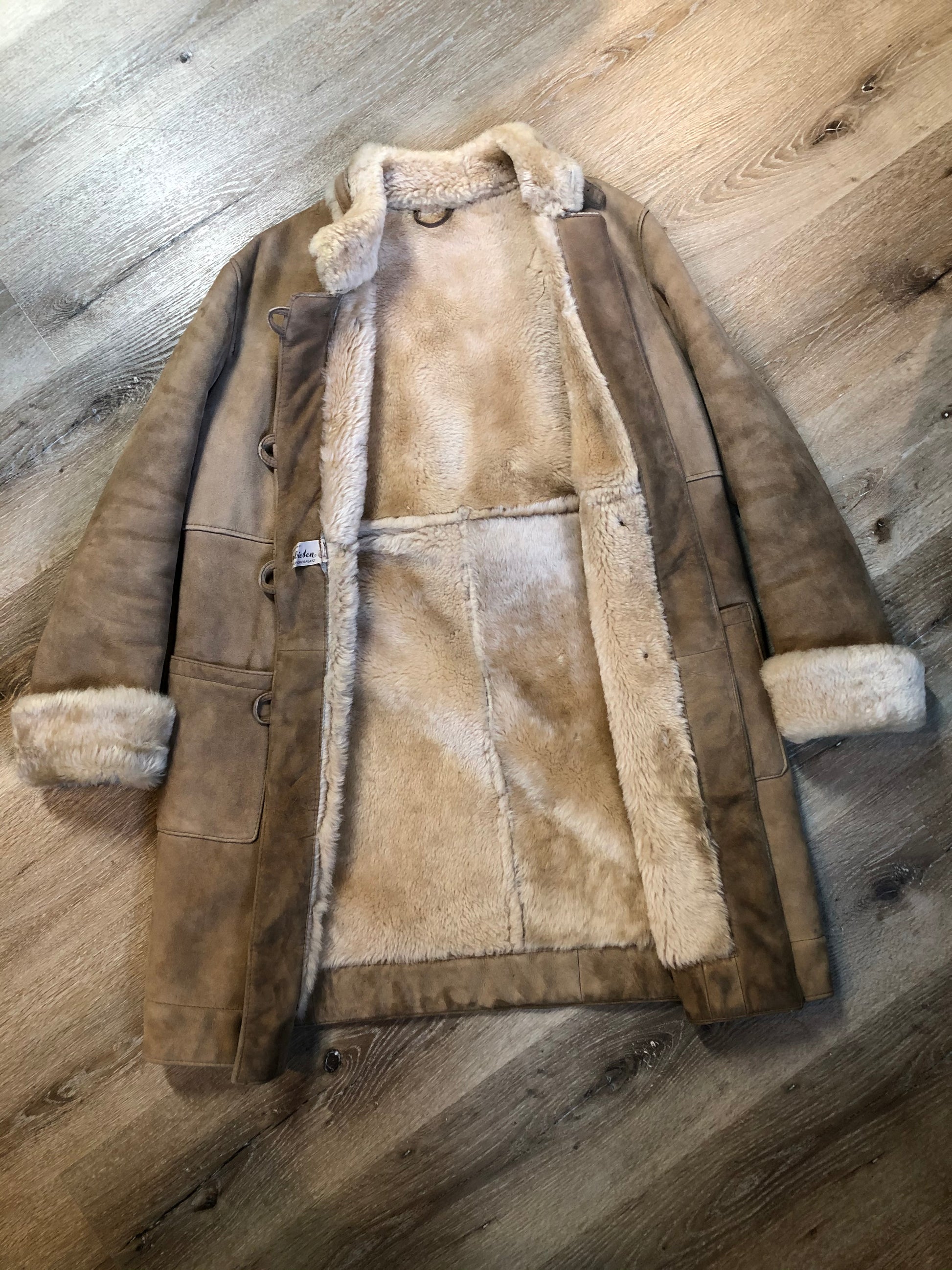 Kingspier Vintage - Karl Inderbieten shearling coat with light brown suede on the outside and soft fur on the inside. This coat is double breasted with button closures, shearling trim and a unique choker detail with brass clasp at the collar. Size medium/ large