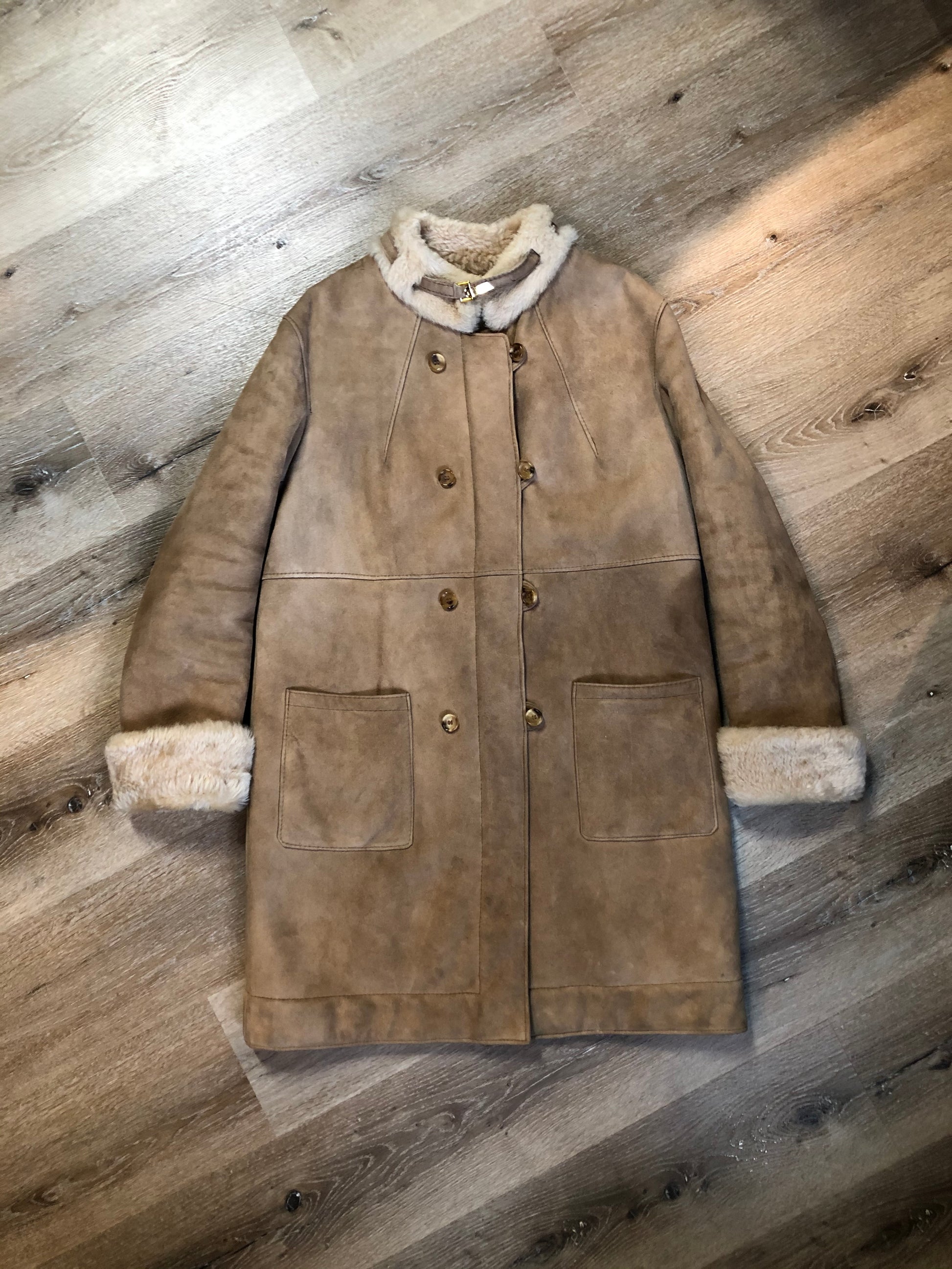 Kingspier Vintage - Karl Inderbieten shearling coat with light brown suede on the outside and soft fur on the inside. This coat is double breasted with button closures, shearling trim and a unique choker detail with brass clasp at the collar. Size medium/ large