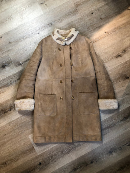 Kingspier Vintage - Karl Inderbieten shearling coat with light brown suede on the outside and soft fur on the inside. This coat is double breasted with button closures, shearling trim and a unique choker detail with brass clasp at the collar. Size medium/ large