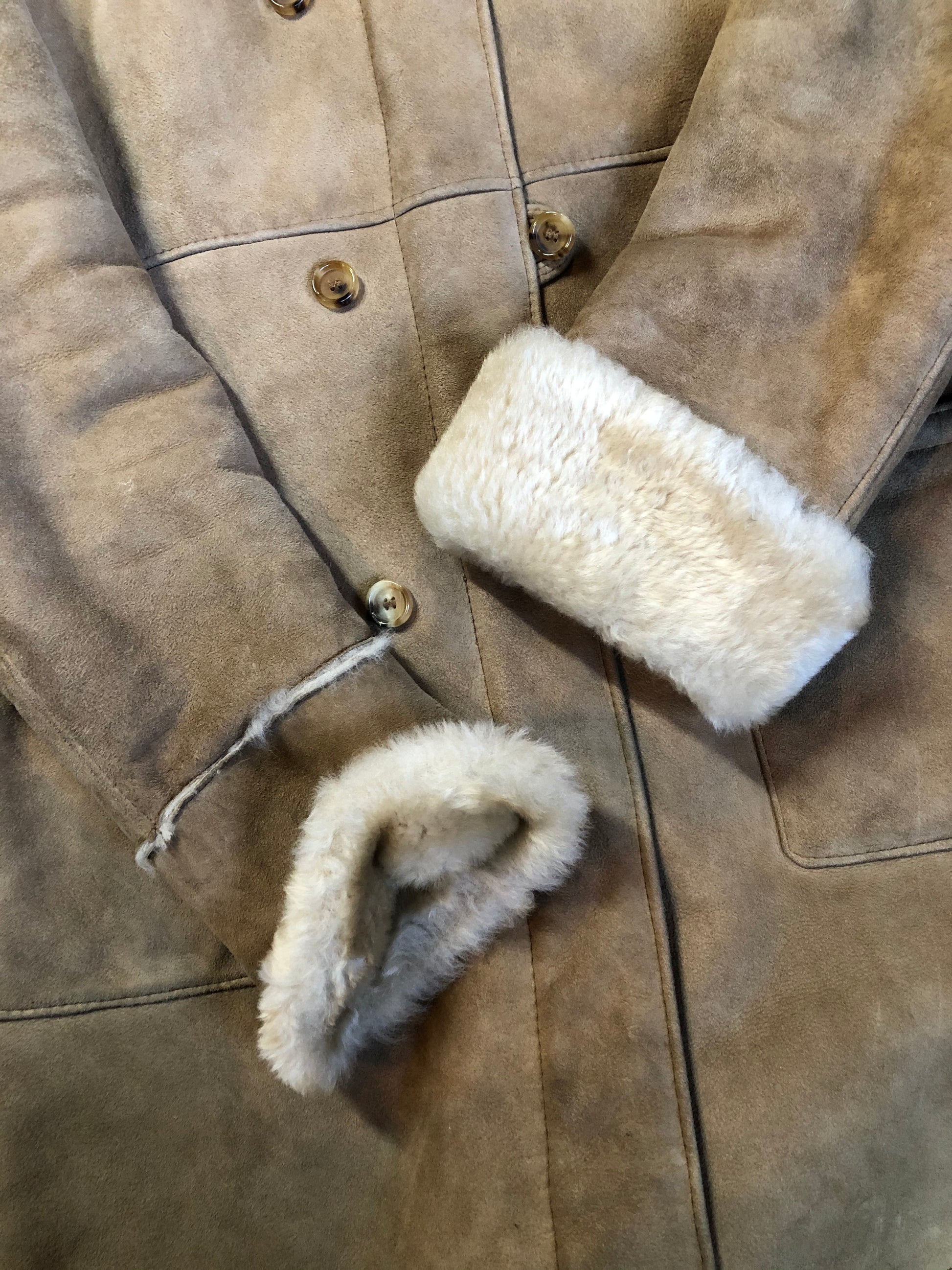 Kingspier Vintage - Karl Inderbieten shearling coat with light brown suede on the outside and soft fur on the inside. This coat is double breasted with button closures, shearling trim and a unique choker detail with brass clasp at the collar. Size medium/ large