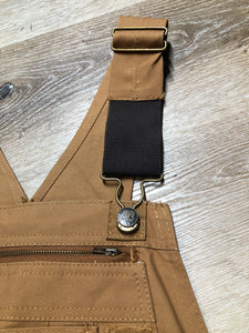 Kingspier Vintage - Berns sleeveless duck canvas overalls in tan brown. Overalls feature adjustable shoulder straps with buckle fastening, hammer loop, patch pocket on the chest, side utility pockets, pockets in the front and back, overalls button at the waist and have reinforced knees. Size 32X32.