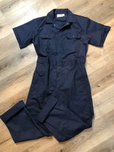 Load image into Gallery viewer, Kingspier Vintage - Vintage Deadstock Anchor Textiles short sleeve navy coveralls with snap closures, elastic waistband, flap pockets on the chest, slash pockets in the front and patch pockets in the back. Union made in Canada. Size medium/ large.
