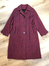 Load image into Gallery viewer, Kingspier Vintage - Mills Brothers red, black and blue houndstooth wool coat. The colours in the houndstooth come together to make a deep purple. This coat features button closures, vertical pockets, knit inner cuffs, a satin lining and zip out genuine chamois inner- lining. Made in Canada. Size medium/ large.
