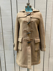 Vintage Gloverall tan duffle coat, with zipper and antler toggle closures, hood and two flap pockets.

80% wool/ 20% polyester
Made in England
Size 40
