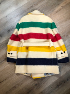 Kingspier Vintage - Genuine Hudson’s Bay Company point blanket coat in the iconic multistripe colours. The coat features flap pockets and hand warmer pockets, double breasted button closures and belt. Made in Canada. Men’s size 46.
