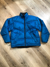 Load image into Gallery viewer, Kingspier Vintage - Vintage Mobius reversible blue and black down filled ski jacket.

This jacket features reversible blue side and black side, zipper closure, two pockets, Logo printed across the back collar,100% polyester shell and 80% down/ 20% feather fill.

Made in Vietnam.
Size Medium.
