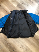 Load image into Gallery viewer, Kingspier Vintage - Vintage Mobius reversible blue and black down filled ski jacket.

This jacket features reversible blue side and black side, zipper closure, two pockets, Logo printed across the back collar,100% polyester shell and 80% down/ 20% feather fill.

Made in Vietnam.
Size Medium.
