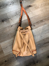 Load image into Gallery viewer, Kingspier Vintage - KGB Orange and peach leather bucket bag with drawstring top closure, adjustable strap and side zip pockets.

Length - 11.5”
Width - .5.5”
Height - 13.5”
Strap - 32” - 29”

This purse is in great condition with some wear in the strap.
