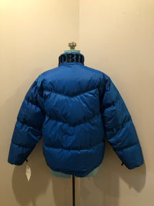Kingspier Vintage - Vintage Mobius reversible blue and black down filled ski jacket.

This jacket features reversible blue side and black side, zipper closure, two pockets, Logo printed across the back collar,100% polyester shell and 80% down/ 20% feather fill.

Made in Vietnam.
Size Medium.