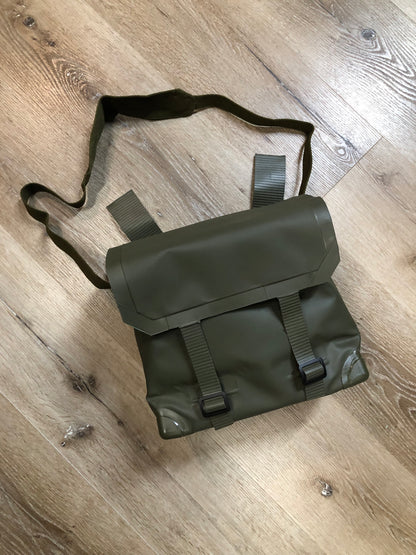 Kingspier Vintage - Deadstock Dutch military issue shoulder bag in dark olive made with waterproof PVC. This bag features a divided main compartment with protective inside flaps that ties in the center and an adjustable canvas shoulder strap.