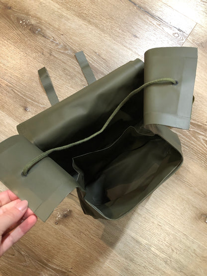 Kingspier Vintage - Deadstock Dutch military issue shoulder bag in dark olive made with waterproof PVC. This bag features a divided main compartment with protective inside flaps that ties in the center and an adjustable canvas shoulder strap.