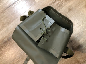 Kingspier Vintage - Deadstock Dutch military issue shoulder bag in dark olive made with waterproof PVC. This bag features a divided main compartment with protective inside flaps that ties in the center and an adjustable canvas shoulder strap.