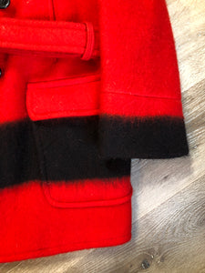 Kingspier Vintage - Genuine Hudson’s Bay Company point blanket coat in red with thick black stripe. The coat features flap pockets and hand warmer pockets, double breasted button closures and belt. Made in Canada. Mens size 48.