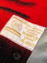 Load image into Gallery viewer, Kingspier Vintage - Genuine Hudson’s Bay Company point blanket coat in red with thick black stripe. The coat features flap pockets and hand warmer pockets, double breasted button closures and belt. Made in Canada. Mens size 48.
