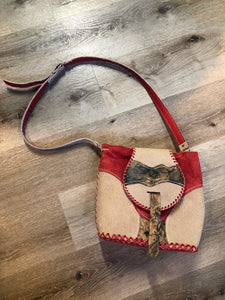 Kingspier Vintage - Tan and red saddle bag with red leather stitching, one large inside compartment and an adjustable shoulder strap.

