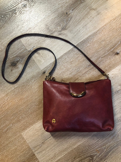 Kingspier Vintage - Etienne Aigner leather crossbody bag with brass hardware, zipper top closure and snap front closure.
