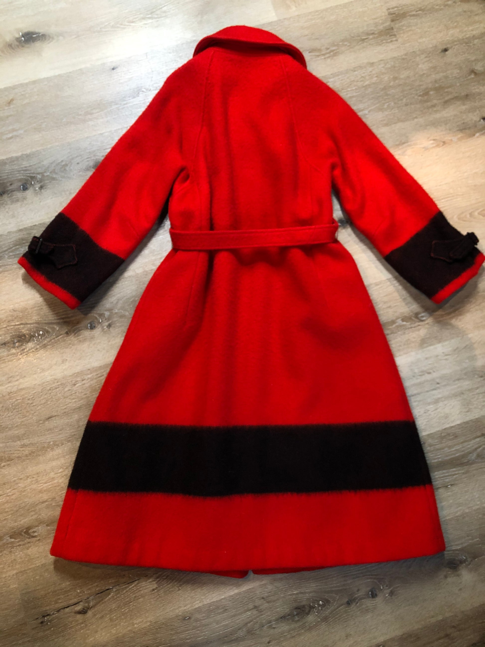 Kingspier Vintage - Hudson’s Bay Company red and black stripe 100% virgin wool point blanket coat in a swing coat style with belt, buckle detail at the collar, button closures, slash pockets and red lining. Size medium/ large.
