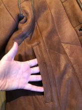 Load image into Gallery viewer, Kingspier Vintage - Vintage “Christ German Leather Fashion” full length buttery soft shearling coat with button closures, two front pockets and removable shoulder pads.

Size 40/ medium/ large
